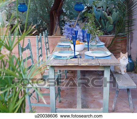 Stock Photograph - Laid table on a terrace. Fotosearch