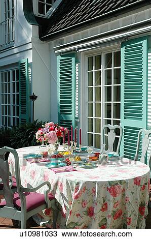 Stock Image - Laid table on terrace. Fotosearch