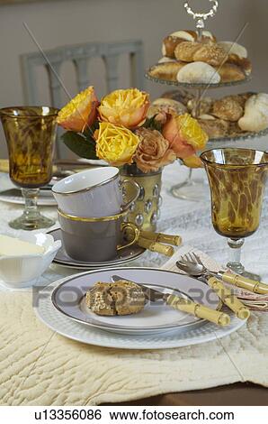Laid table with bread rolls and flower arrangement View Large Photo Image Stock Photograph - Laid table with bread rolls and flower arrangement. Fotosearch