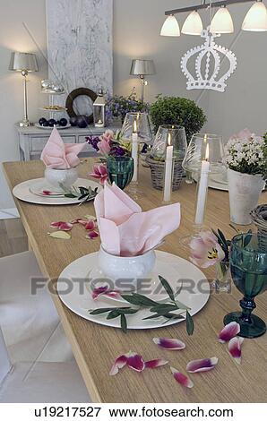 Stock Photo - Laid table with flowers and candles. Fotosearch