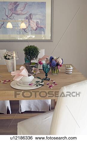Stock Photograph - Laid table with flowers and candles. Fotosearch