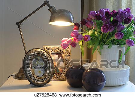 Stock Photo - Lamp, bunch of flowers and pictures. Fotosearch