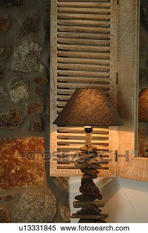 Lamp in front of window shutters and natural stone wall View Large Photo Image Stock Photography - Lamp in front of window shutters and natural stone wall. Fotosearch