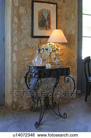 Stock Photograph - Lamp und decorative objects on table. Fotosearch