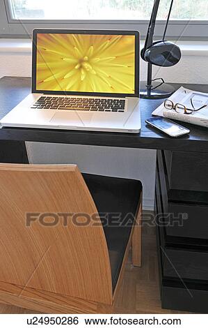 Laptop on desk View Large Photo Image Stock Photograph - Laptop on desk. Fotosearch