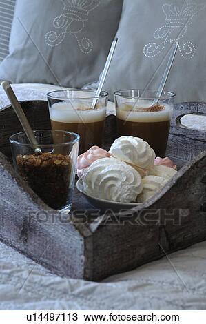Stock Image - Latte Macchiato and pastry on bed. Fotosearch