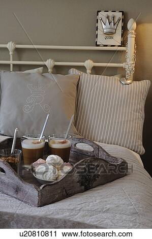 Stock Image - Latte Macchiato and pastry on bed. Fotosearch