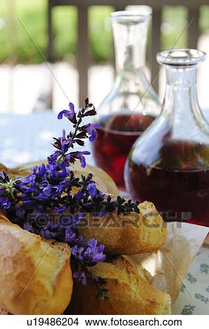Picture - Lavender blossoms, red wine and baguette. Fotosearch