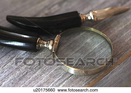 Stock Image - Letter opener and magnifying glass. Fotosearch