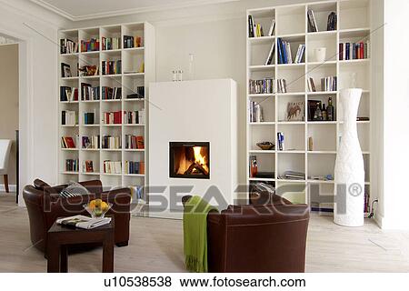 Stock Photo - Living room with armchairs by the fireplace. Fotosearch