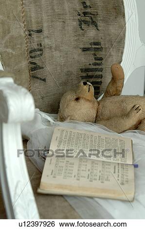 Stock Photograph - Lying teddy bear and old songbook. Fotosearch