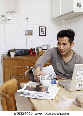 Man reading newspaper at home View Large Photo Image Stock Image - Man reading newspaper at home. Fotosearch