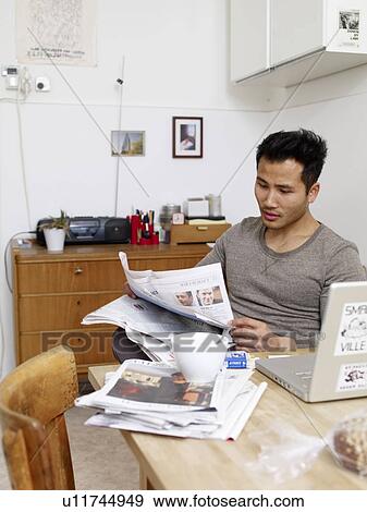Man reading newspaper at home View Large Photo Image Stock Photo - Man reading newspaper at home. Fotosearch
