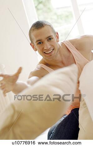 Man throwing cushions View Large Photo Image Stock Photograph - Man throwing cushions. Fotosearch