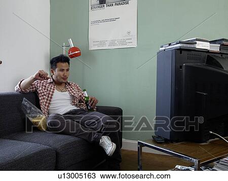Man watching TV with beer and chips View Large Photo Image Stock Image - Man watching TV with beer and chips. Fotosearch