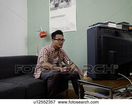 Man watching TV with beer and chips View Large Photo Image Stock Photo - Man watching TV with beer and chips. Fotosearch