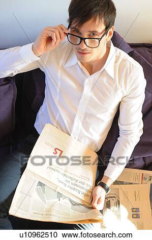 Man with glasses reading newspaper View Large Photo Image Stock Image - Man with glasses reading newspaper. Fotosearch