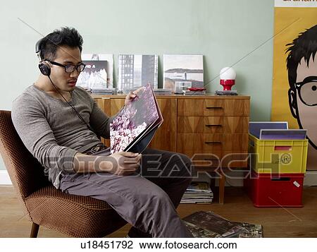 Man with headphones holding record View Large Photo Image Stock Image - Man with headphones holding record. Fotosearch