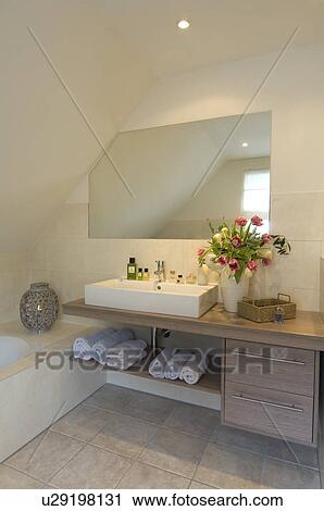 Stock Image - Modern bathroom with bunch of flowers. Fotosearch