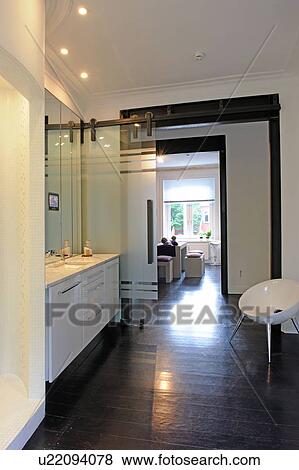 Modern bathroom with passage to open plan kitchen View Large Photo Image Stock Photo - Modern bathroom with passage to open plan kitchen. Fotosearch