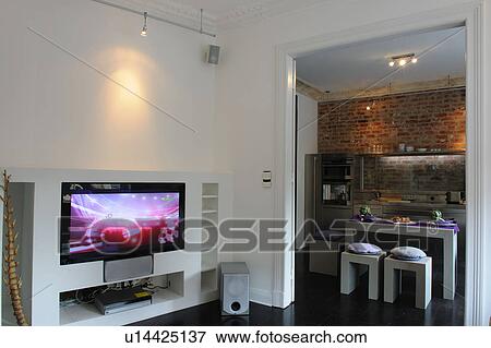 Modern open plan kitchen and widescreen TV in living room View Large Photo Image Stock Photo - Modern open plan kitchen and widescreen TV in living room. Fotosearch