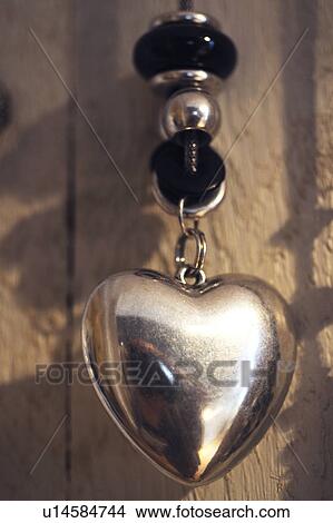 Necklace with heart-shaped pendant View Large Photo Image Picture - Necklace with heart-shaped pendant. Fotosearch