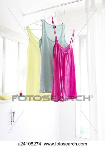 Nightdresses hanging in bathroom View Large Photo Image Picture - Nightdresses hanging in bathroom. Fotosearch