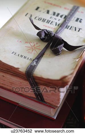 Stock Image - Old book wrapped with ribbon. Fotosearch