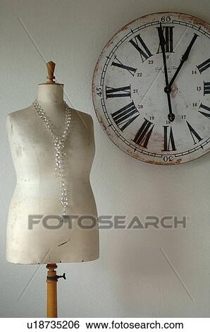 Old wall clock and tailors dummy with necklace View Large Photo Image Stock Photograph - Old wall clock and tailors dummy with necklace. Fotosearch