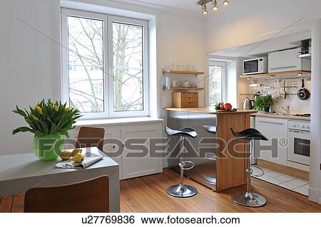 Stock Photograph - Open plan kitchen with dining area. Fotosearch