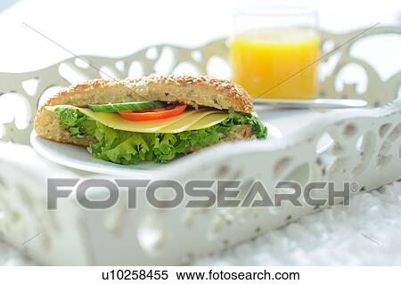 Orange juice and sandwich on tray View Large Photo Image Stock Photography - Orange juice and sandwich on tray. Fotosearch