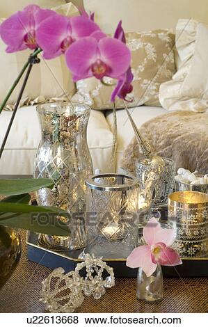 Stock Photo - Orchid and glasses with candles. Fotosearch