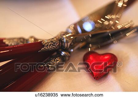 Stock Photography - Ornate cutlery and decorative heart. Fotosearch