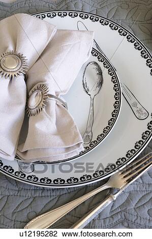 Stock Image - Ornate plates, cutlery and napkins. Fotosearch