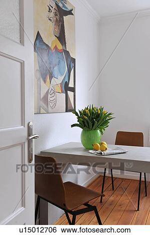 Stock Photograph - Painting above table with bunch of flowers. Fotosearch