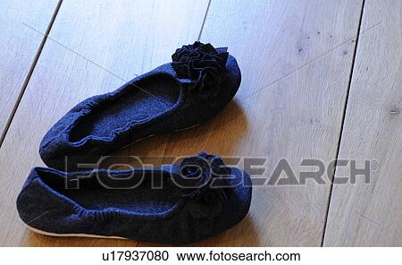 Stock Image - Pair of ladies shoes on wooden floor. Fotosearch