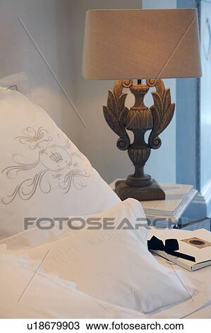 Stock Image - Pillow with imprint and bedside lamp. Fotosearch