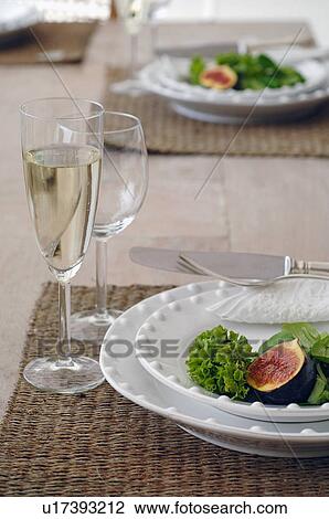 Plate with fig and lettuce leaf and glass of champagne View Large Photo Image Stock Image - Plate with fig and lettuce leaf and glass of champagne. Fotosearch