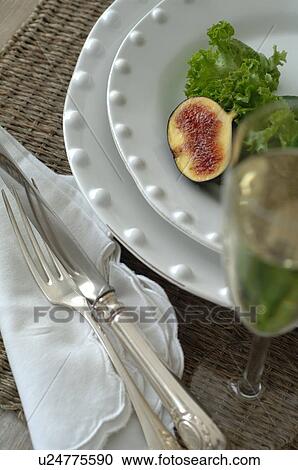 Plate with fig and lettuce leaf and glass of champagne View Large Photo Image Stock Image - Plate with fig and lettuce leaf and glass of champagne. Fotosearch