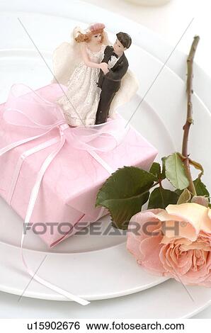 Plate with gift, rose and bride and groom figurines View Large Photo Image Stock Photograph - Plate with gift, rose and bride and groom figurines. Fotosearch