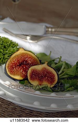 Plate with halved fig and lettuce View Large Photo Image Stock Image - Plate with halved fig and lettuce. Fotosearch
