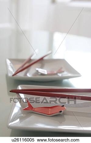 Stock Photography - Plates with chopsticks and fake fish. Fotosearch