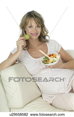 Pregnant woman eating fruit salad View Large Photo Image Stock Image - Pregnant woman eating fruit salad. Fotosearch
