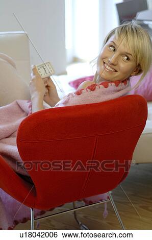 Relaxed young woman with alarm clock at home View Large Photo Image Stock Photograph - Relaxed young woman with alarm clock at home. Fotosearch