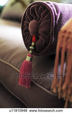Roll cushion with tassel on couch View Large Photo Image Stock Photo - Roll cushion with tassel on couch. Fotosearch