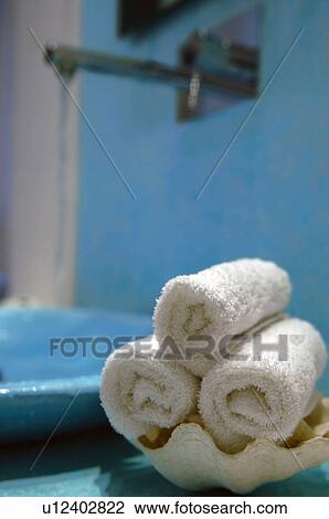 Stock Image - Rolls of towels at washbasin. Fotosearch