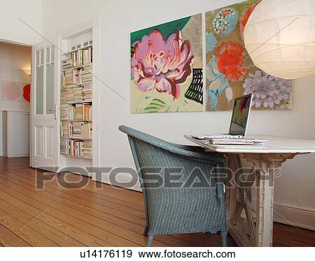 Room with bookshelf, paintings and laptop on table View Large Photo Image Stock Photo - Room with bookshelf, paintings and laptop on table. Fotosearch