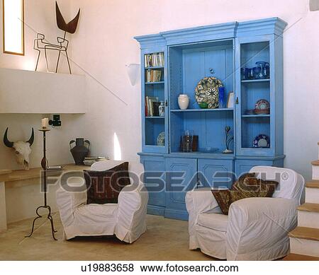 Room with two armchairs and blue cabinet View Large Photo Image Stock Photo - Room with two armchairs and blue cabinet. Fotosearch