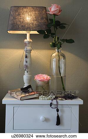 Rose and table lamp on dresser View Large Photo Image Picture - Rose and table lamp on dresser. Fotosearch