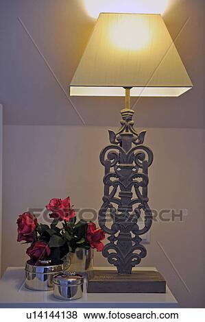 Stock Photo - Rose blossoms and table lamp. Fotosearch